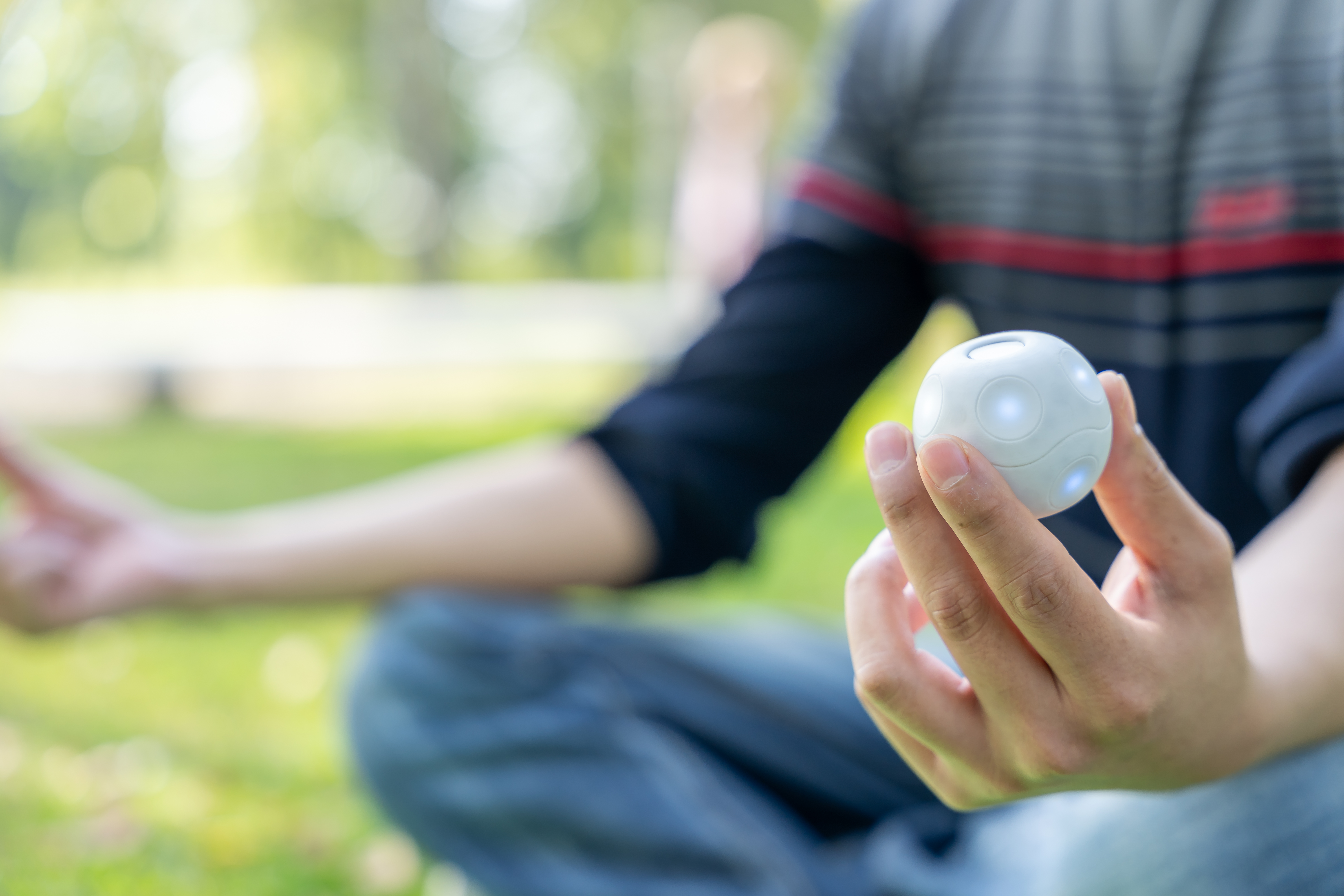 A seated person holding PALL0 in their hand